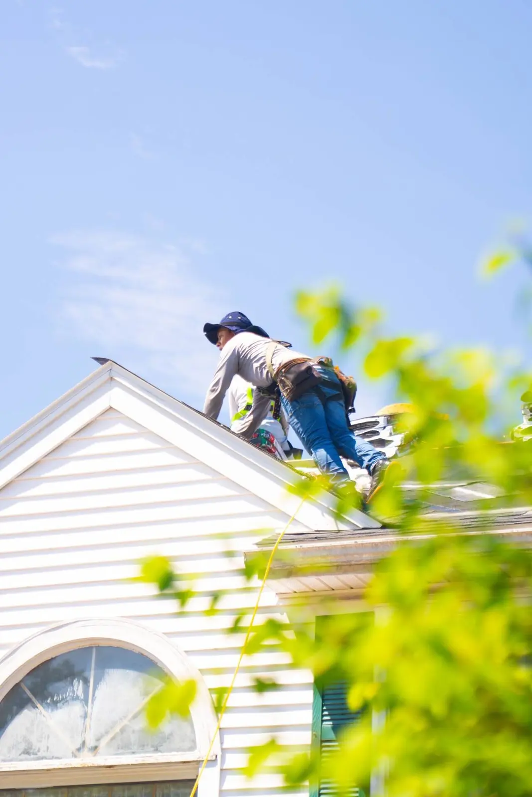Safe Home Roofing crew member installing shingles